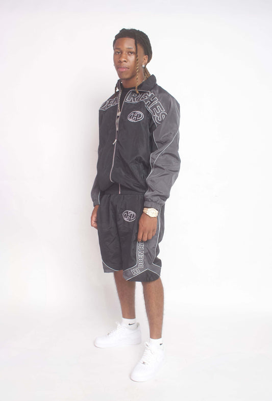 Men wearing HIDDENRICHES windbreaker jacket and shorts set in lightweight breathable fabric for casual streetwear and outdoor activities